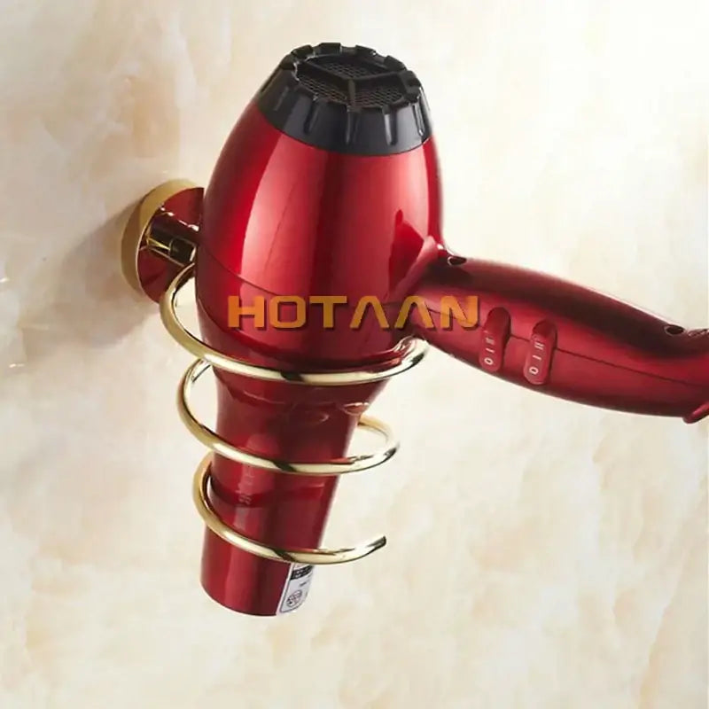 Red hair dryer with black nozzle mounted on modern gold spiral hair dryer holder bathroom anti rust rack