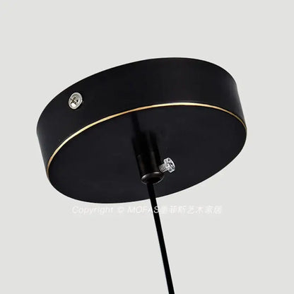 Black circular pendant light fixture with gold trim and aluminum alloy light source for modern dining room use