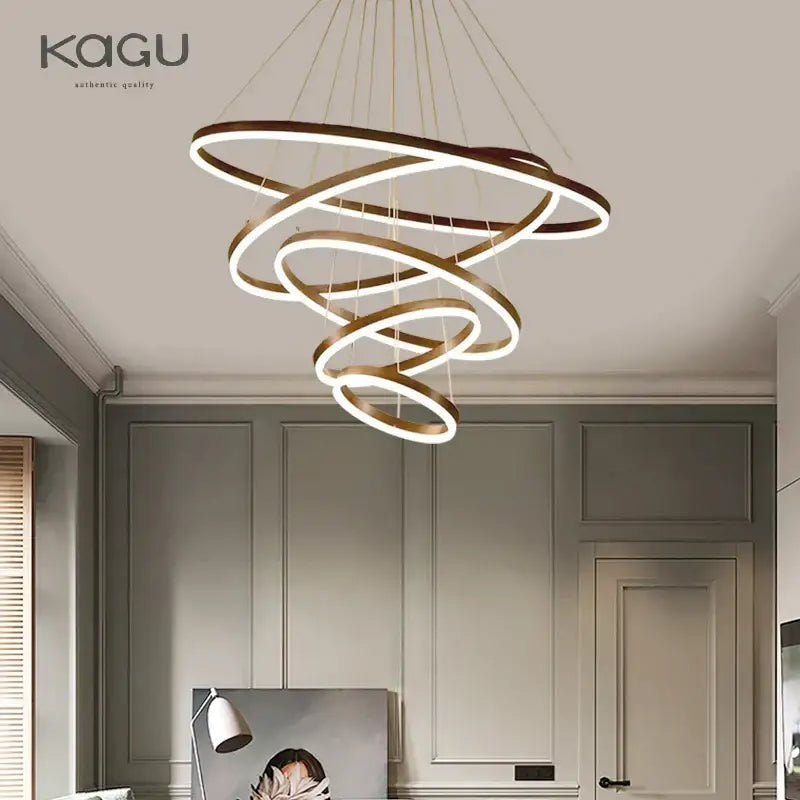 Modern gold spiral pendant light with interlocking gold rings and glowing white led lighting for dining room decorbites black led