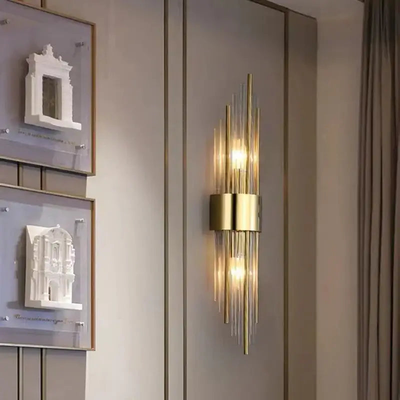 Modern gold stainless steel wall lamp with clear crystal vertical glass rods and central cylindrical base for bedroom sconce
