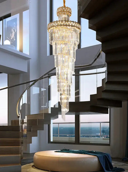 Modern gold stainless steel crystal chandelier with cascading clear and gold-toned elements above staircase light