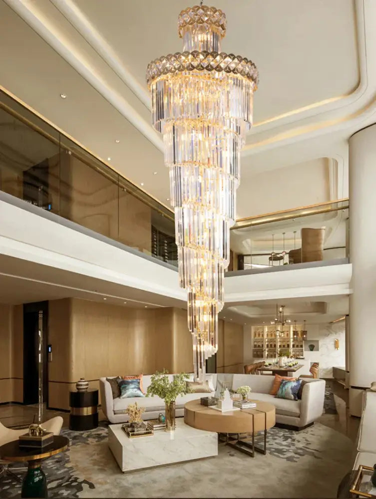 Modern gold stainless steel crystal chandelier with cascading glass prisms and gold stainless steel frame for staircase lighting