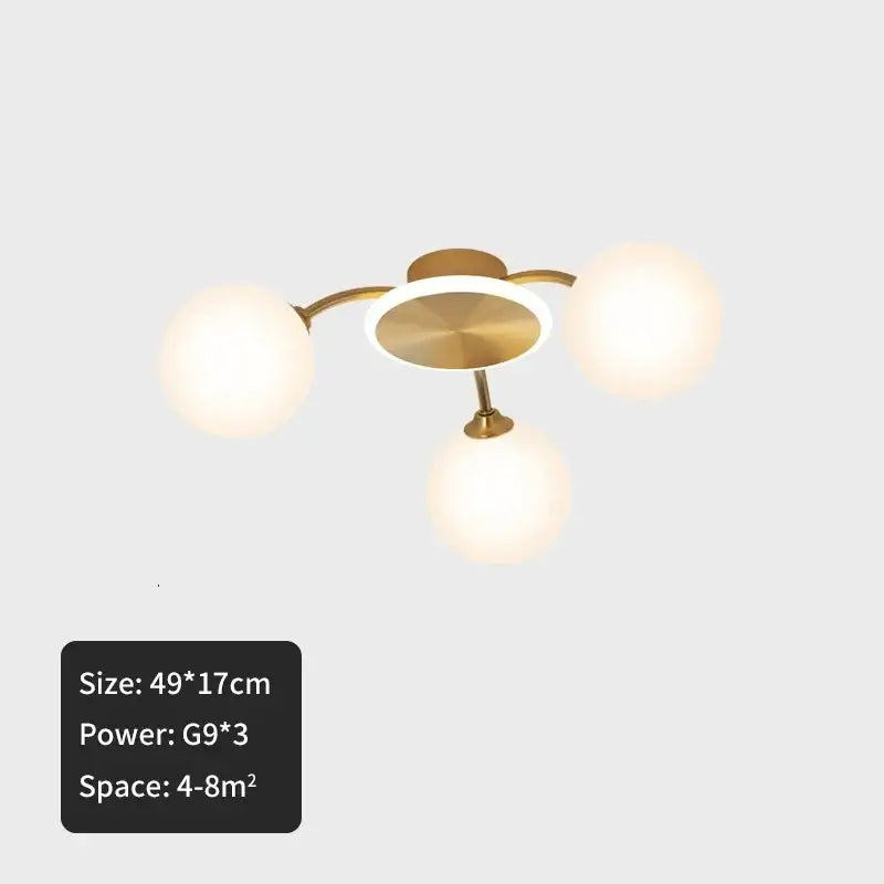 Modern brass-finished ceiling light with three frosted ball glass globe shades for living room illumination