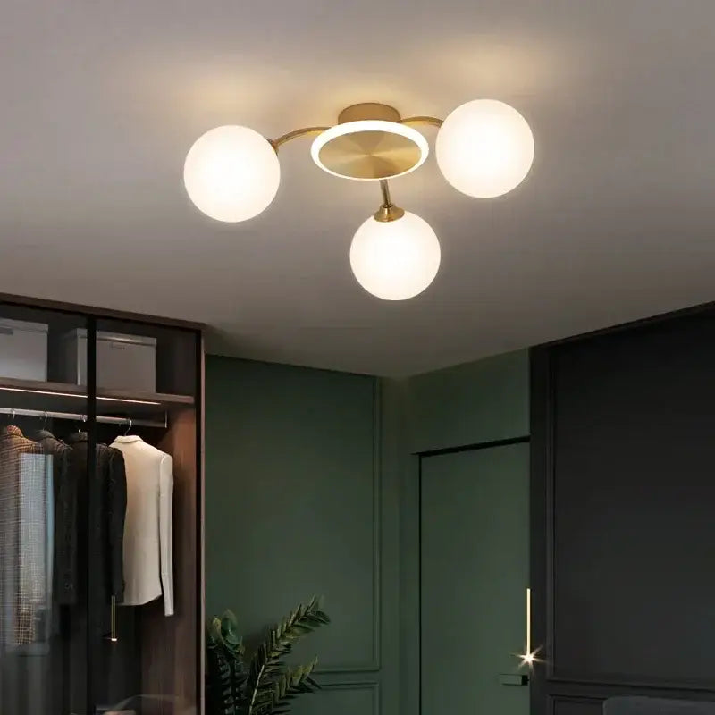 Modern gold starburst ball glass ceiling light with brass finish and three frosted glass globe shades for living room