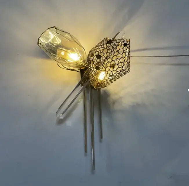 Modern gold steel led pendant lights feature a clear glass bulb with a gold-toned wire mesh cage decorbites gold steel design