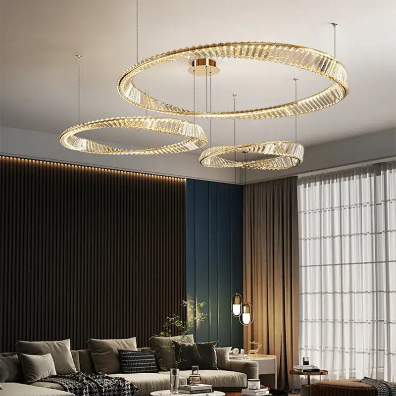 Modern gold steel pendant light with circular gold steel rings and crystal accents for dining room use
