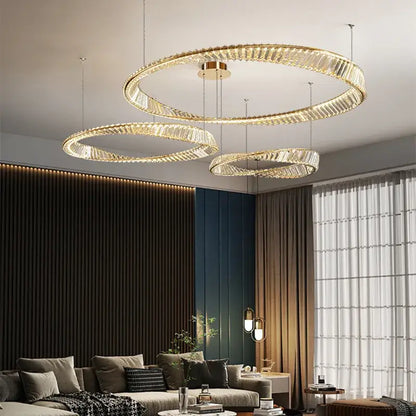 Modern gold steel pendant light with circular gold steel rings and crystal accents for dining room use