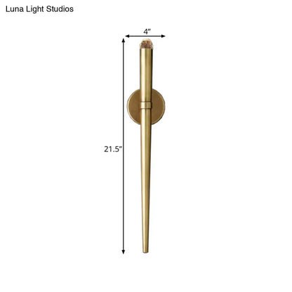 A sleek 21.5-inch tall modern gold tapered brass wall lamp for living room lighting with a textured crystal cap