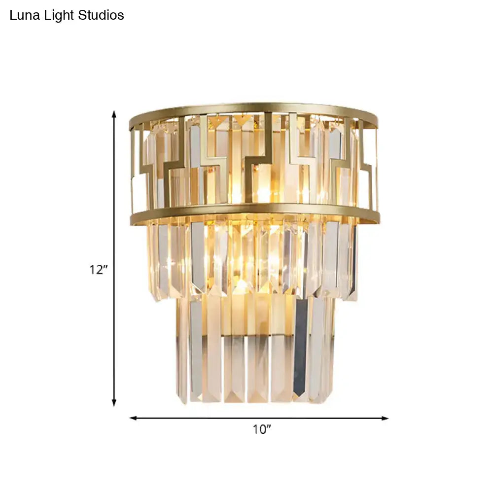 Modern gold tiered bedside wall lamp with crystals featuring geometric metal framing and tiered crystal prisms