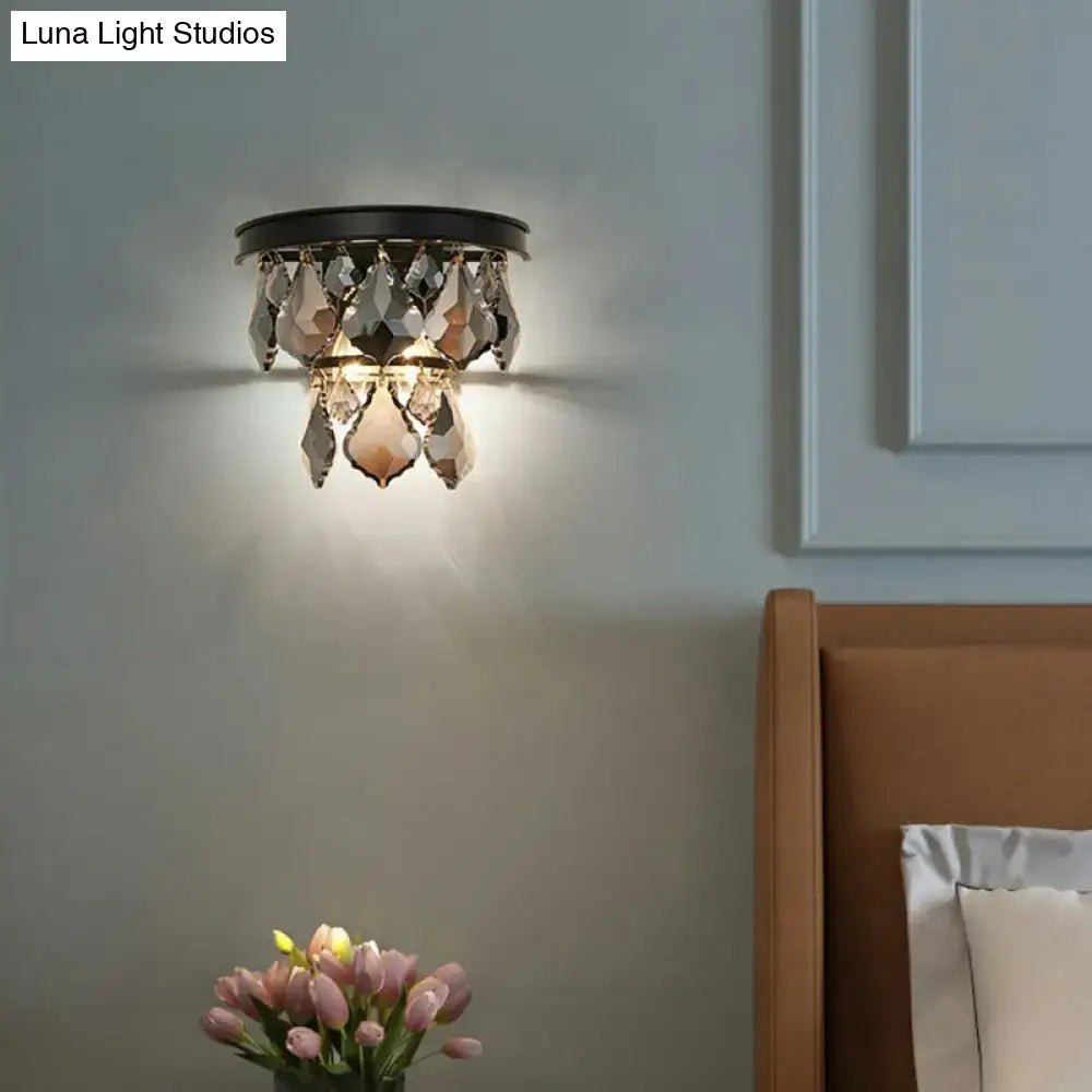 Black crystal chandelier-style tiered sconce light with faceted teardrop crystals bedside wall mount fixture