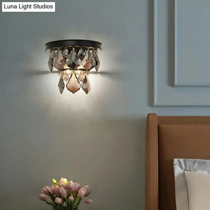 Black crystal chandelier-style tiered sconce light with faceted teardrop crystals bedside wall mount fixture