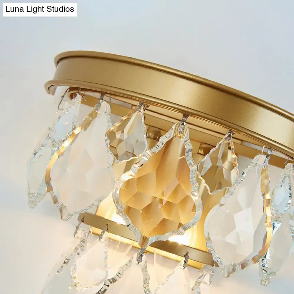 Modern gold tiered sconce light fixture with crystal teardrop and geometric glass pendants for bedside wall mount
