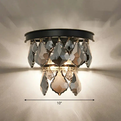 Black-framed crystal chandelier with faceted teardrop crystals in cascading design for a modern tiered sconce light bedside wall mount