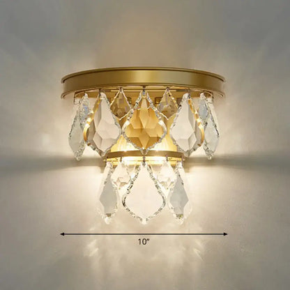 Modern gold tiered sconce light fixture with faceted clear and amber crystals for bedside wall mount