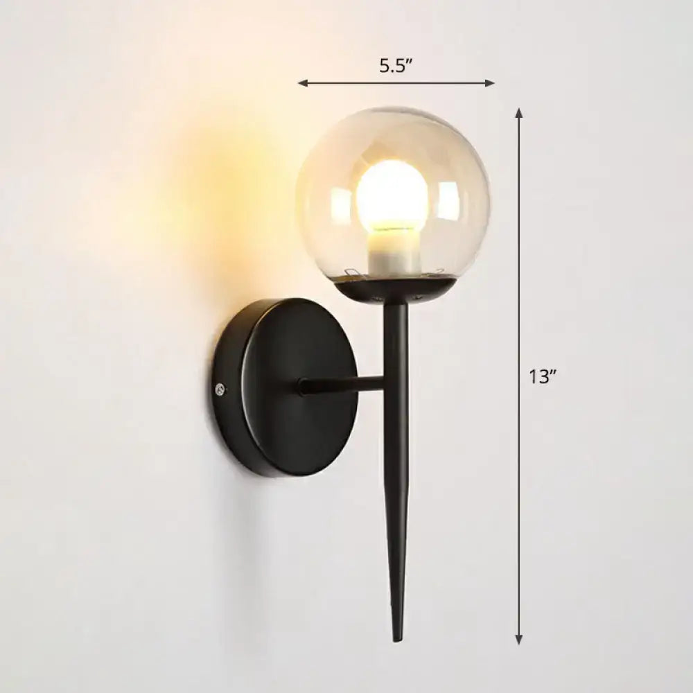 Black metal wall sconce with torch design and clear glass globe featuring an illuminated e26 e27 bulb for corridors