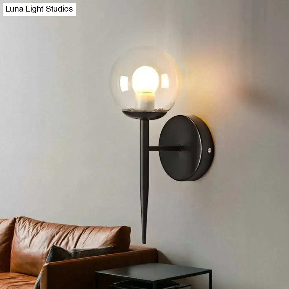 Black metal torch design wall sconce with clear glass globe and illuminated e26 e27 bulb for modern corridor lighting