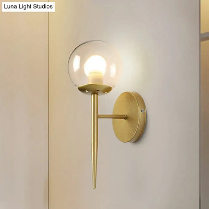 Modern gold torch wall sconce with clear glass globe and slender stem compatible with e26 e27 bulbs for corridor lighting