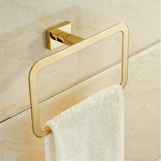 Modern gold towel ranger accessory rack with gold finish and sleek design mounted on a tiled bathroom wall