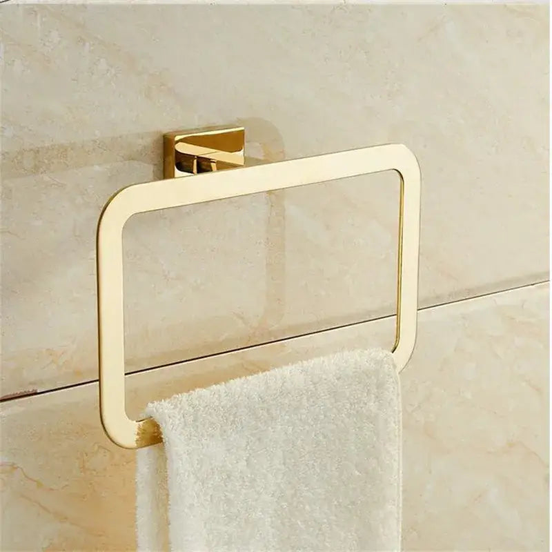 Modern gold towel ranger accessory rack gold-toned rectangular ring with sleek design mounted on tiled wall