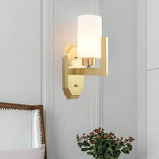 Modern gold tubular wall lamp with a cylindrical frosted glass shade for living room product fixture