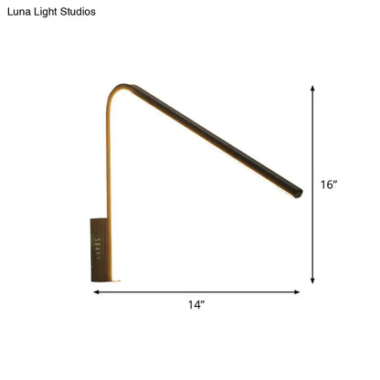 A sleek modern desk lamp with matte black finish and adjustable curved arm emitting warm white light silica gel