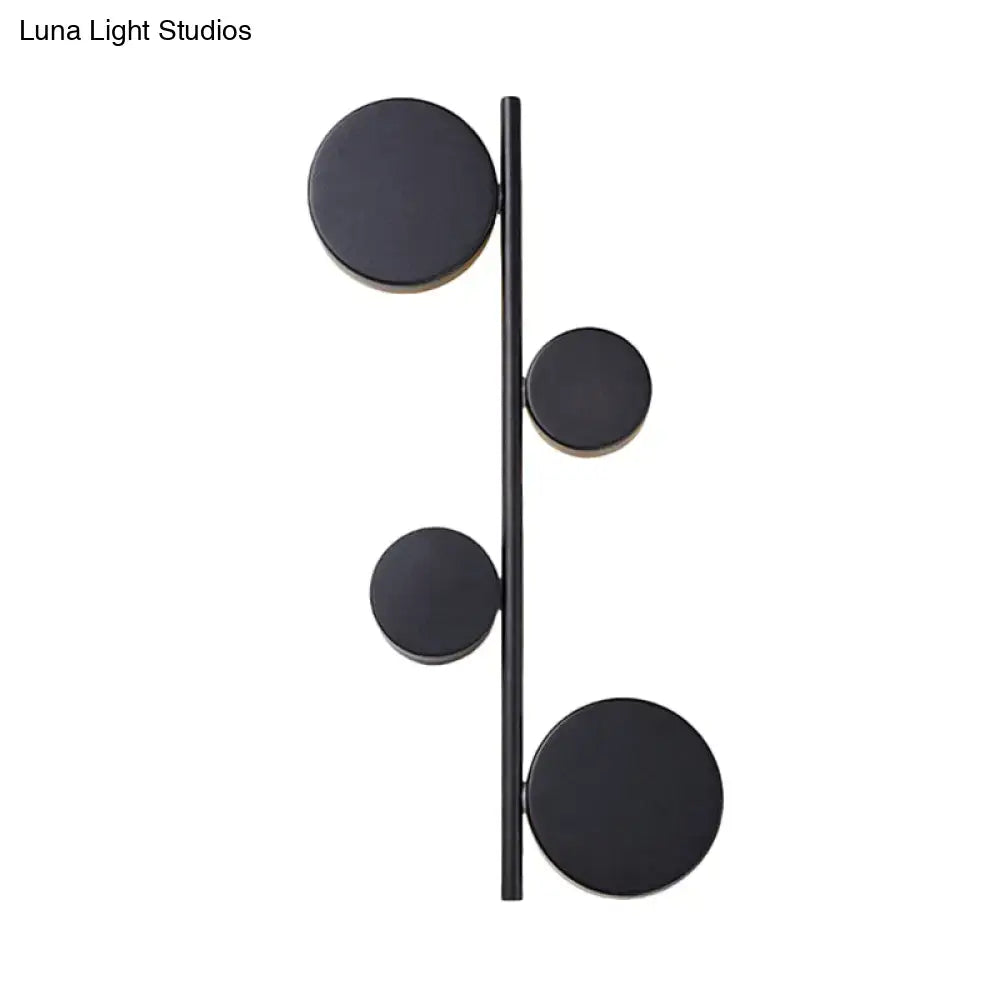 Modern black matte-finished vertical linear sconce light with four circular discs for living room wall decor in black gold finish