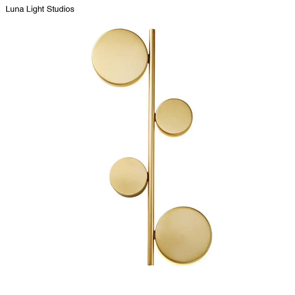 Modern gold vertical linear sconce light with four asymmetrical circular discs in black gold finish for living room