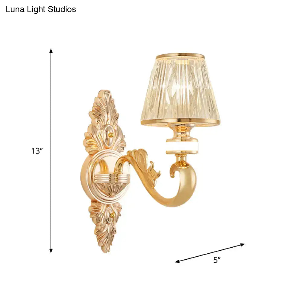 Gold wall sconce lamp fixture with ornate finish and faceted crystal cone shade for bedroom lighting