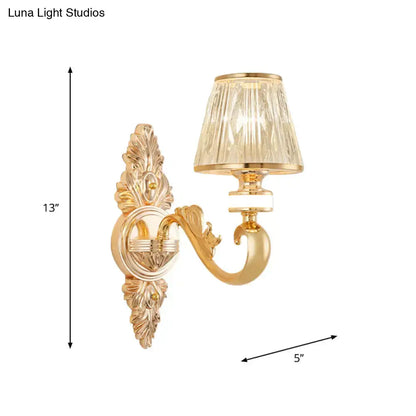 Gold wall sconce lamp fixture with ornate finish and faceted crystal cone shade for bedroom lighting