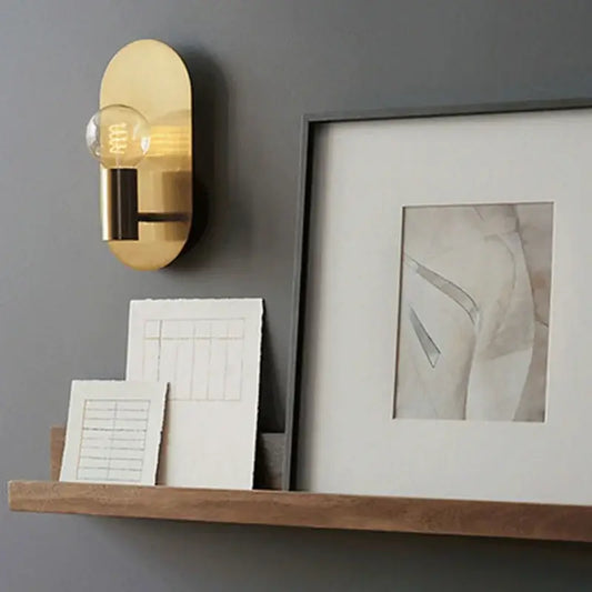 Modern gold wall lamp sconce with a gold-toned oval frame and visible filament bulb for bedroom decorbites wall lamp