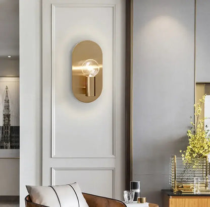 Modern gold wall lamp sconce with gold-toned oval design and visible filament bulb for bedroom decorbites gold wall lamp