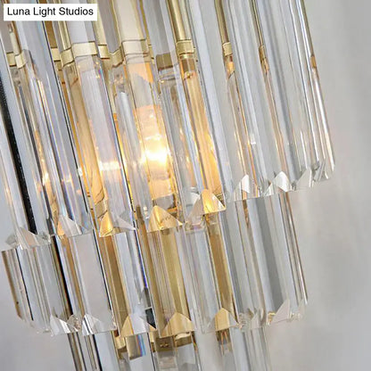 Modern gold wall lamp with cascading clear crystal block prisms and warm light for bedroom lighting