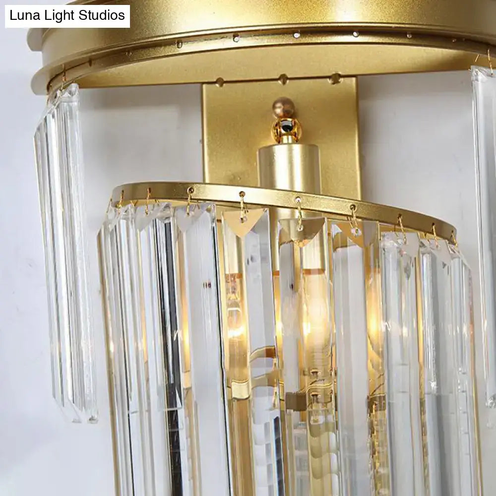 Modern gold wall lamp featuring a gold-finished chandelier with clear crystal block prisms for bedroom use