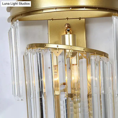 Modern gold wall lamp featuring a gold-finished chandelier with clear crystal block prisms for bedroom use