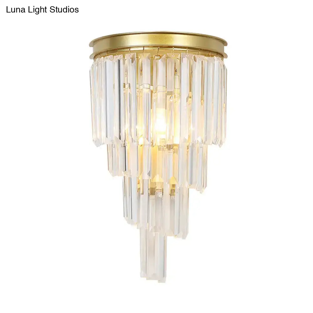 Modern gold wall lamp featuring clear crystal block prisms and a tiered crystal chandelier design for bedroom use