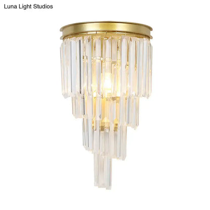 Modern gold wall lamp featuring clear crystal block prisms and a tiered crystal chandelier design for bedroom use