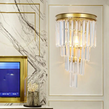 Modern gold wall lamp with clear crystal block prisms in gold tone for elegant bedroom lighting