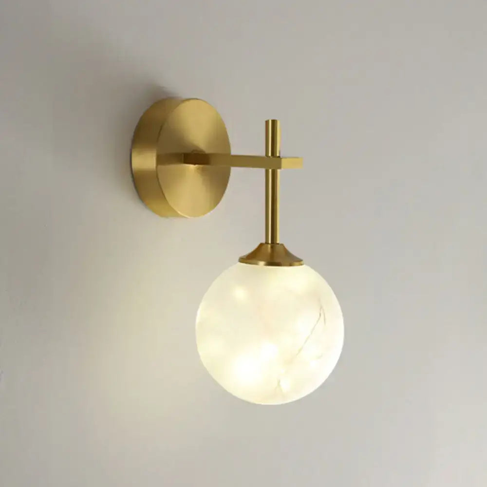 Modern gold wall lamp with frosted glass shade featuring subtle veining designed as a bedroom sconce light type