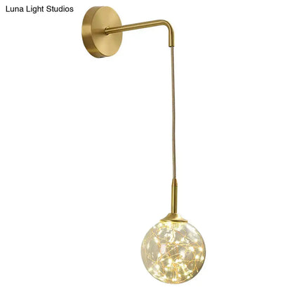 Modern gold wall lamp with curved arm and glass shade featuring warm fairy light type for bedroom sconce use
