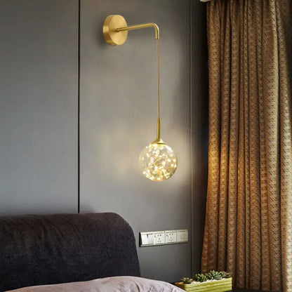 Modern gold wall lamp with frosted glass shade and spherical globe housing warm led fairy lights for bedroom sconce