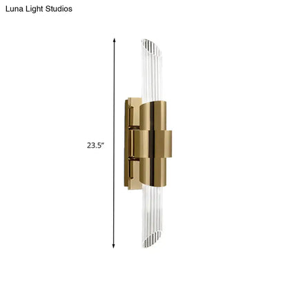 Modern gold wall lamp with vertical glass rods and geometric metal frame featuring a prismatic crystal shade for bedroom