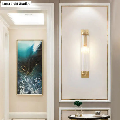 Modern gold wall light fixture with clear glass cylinder and gold metal accents direct wired electric 220v-240v 110v-120v