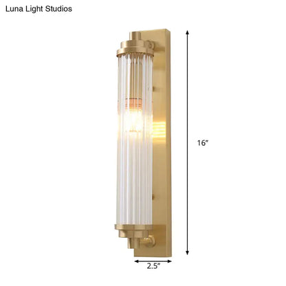 A sleek 16-inch modern gold wall light fixture with frosted glass vertical panels in brushed brass finish direct wired electric