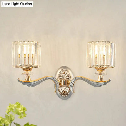 Elegant modern gold wall light with clear crystal shade and silver-gold ornate metal frame for living room sconce