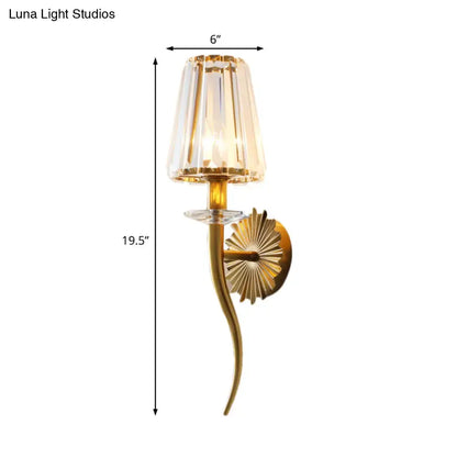 Elegant gold wall light with clear tapered faceted crystal shade and sunburst backplate for stairways