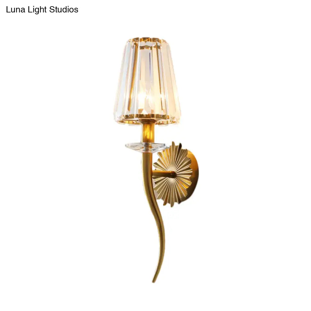 Elegant modern gold wall light with clear tapered faceted crystal shade and sunburst backplate for stairways