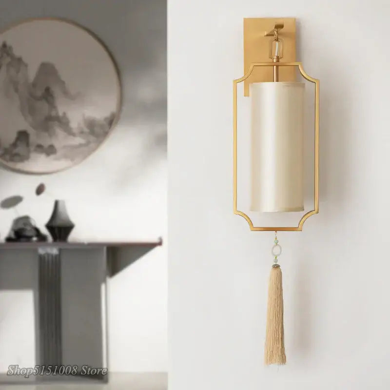 Modern gold wall lights featuring a gold-framed sconce with cream satin tassel shade for elegant living room decorbites copper wall lights