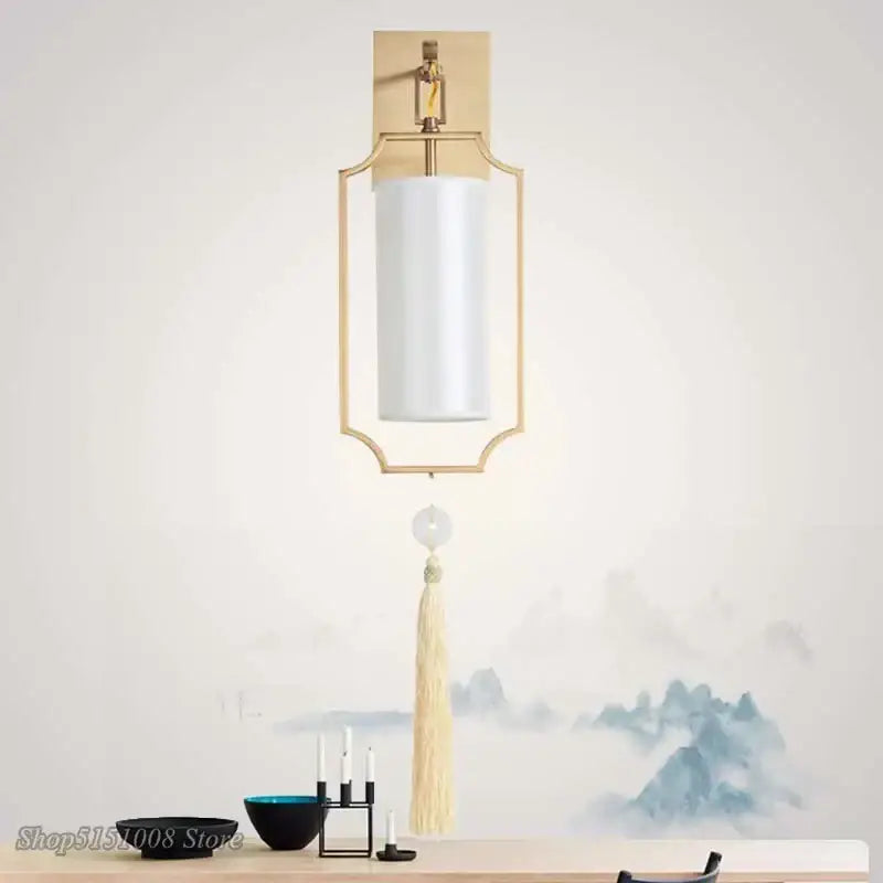 Modern gold wall lights with a geometric design, white cylindrical shade, and beige tassel for living room decorbites copper wall lights