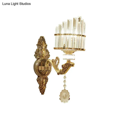 Modern gold wall mount arc sconce with vertical crystal rods and dangling floral pendant for bedroom lighting