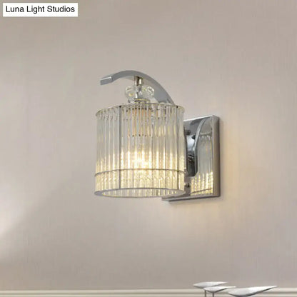 Modern gold wall mounted lamp with clear crystal shade featuring a chrome finished wall sconce and cylindrical glass design